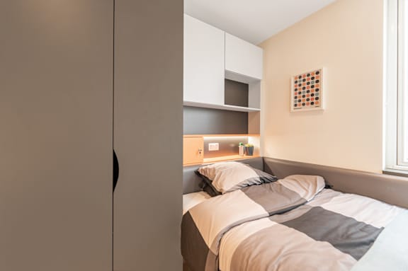 a small bedroom with a bed and a closet