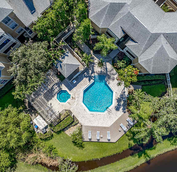 A large house with a pool in the middle of it.