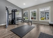 Thumbnail 10 of 10 - A spacious home gym with a variety of equipment.