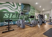 Thumbnail 3 of 10 - A gym with a green wall and a sign that says "Slainte! Good Health!"