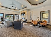 Thumbnail 7 of 10 - A spacious living room with a grey carpet and a variety of seating options.
