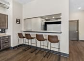 Thumbnail 7 of 10 - Three brown leather bar stools are placed in front of a mirror.