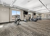 Thumbnail 4 of 10 - A gym with a variety of exercise equipment and a motivational poster on the wall.