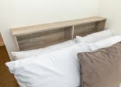 Thumbnail 3 of 8 - a bed with white sheets and a wooden headboard with pillows
