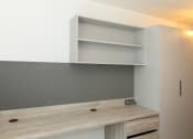 Thumbnail 4 of 8 - a kitchen with white cabinets and a counter top and a shelf