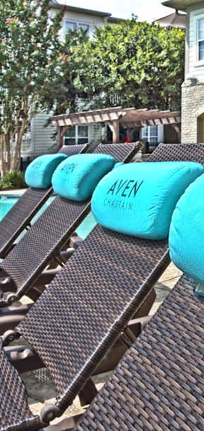 A row of Ayen Chain lounge chairs are arranged on a patio.