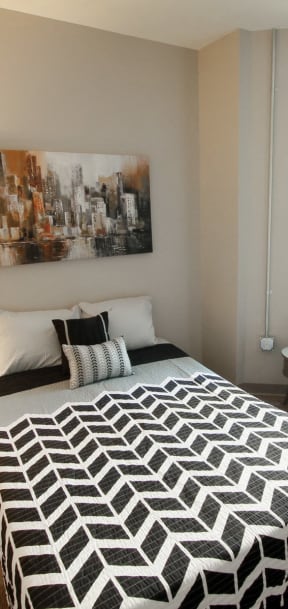 a bedroom with a bed and two windows