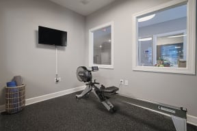 an office with a chair and a television in the corner
