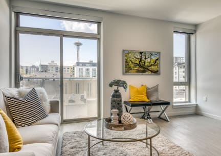 a living room with a large window and a couch and a table