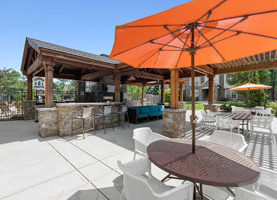 Outdoor grill station tables at Atley on the Greenway Apartments in Ashburn VA