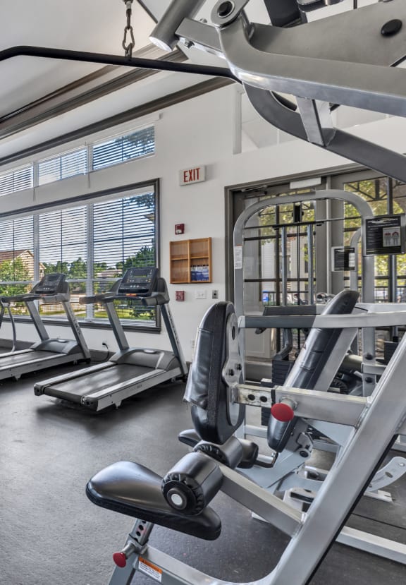 a gym with weights and other exercise equipment and windows