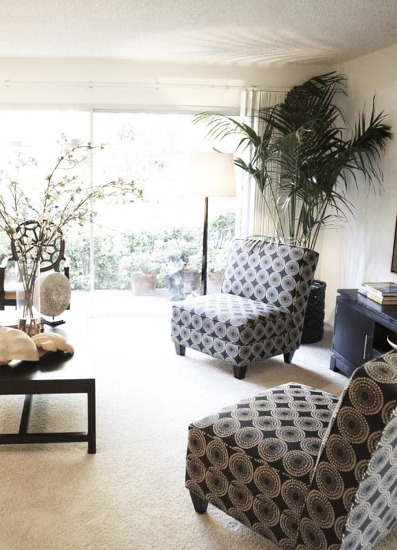 a living room filled with furniture and a large window
