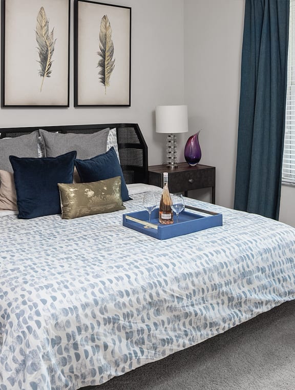 a bedroom with a bed and pictures on the wall