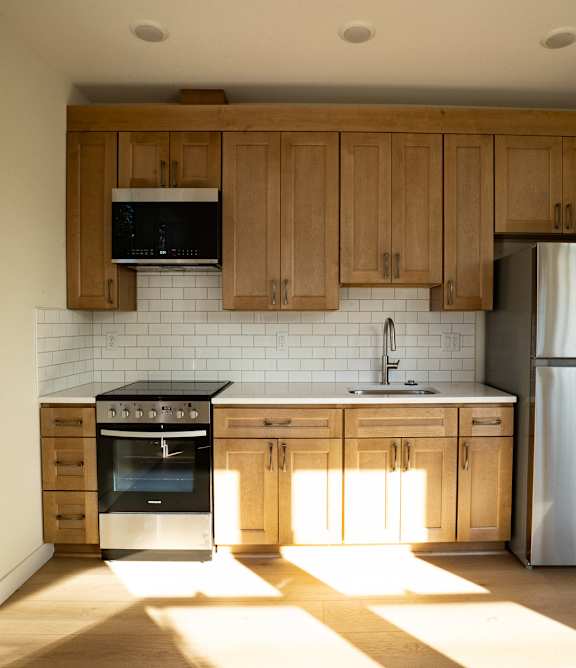 A kitchen with wooden cabinets and stainless steel appliances.