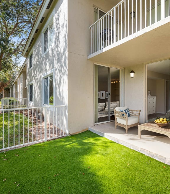 a patio with chairs and a table on a balcony at Gateway Club, Boynton Beach, FL, 33436
