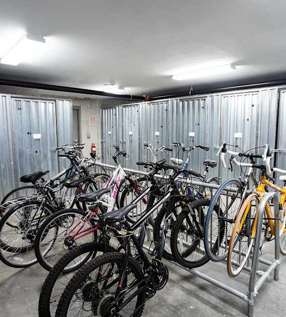 A bike rack full of bicycles in a garage.