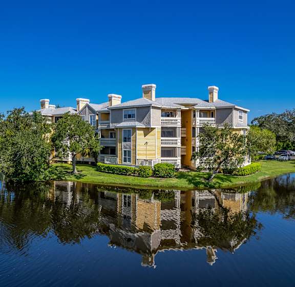 A large house with a fountain in front of it.
