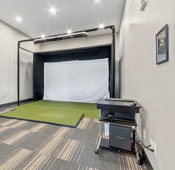 A room with a green mattress and a black table.
