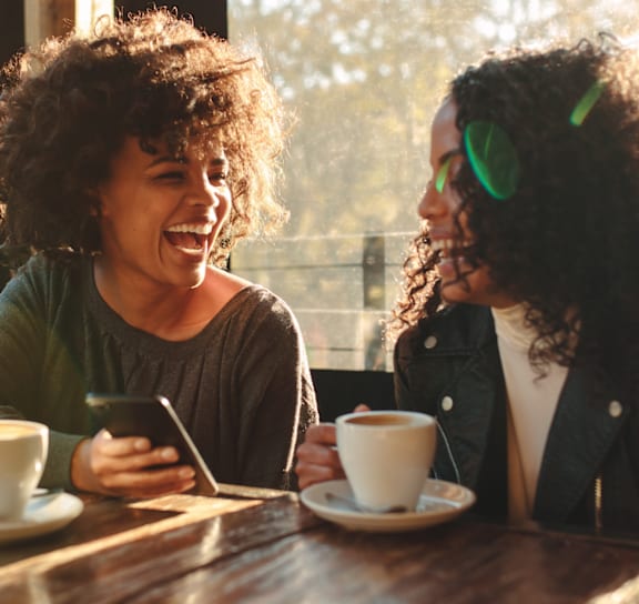 Two people having a conversation over coffee.