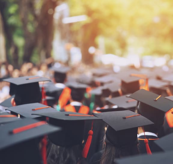 A group of graduates wearing caps and gowns.