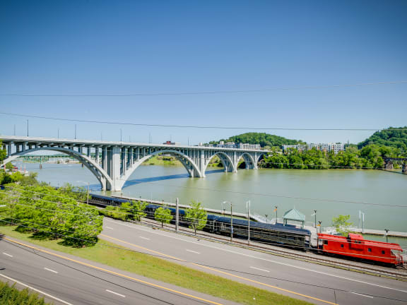a view of a city with a river and a train