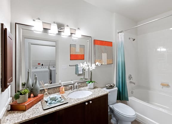 Bathroom with shower tub combo at Atley on the Greenway Apartments in Ashburn VA