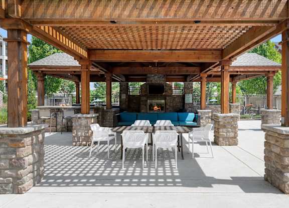 Outdoor grilling area seating at Atley on the Greenway Apartments in Ashburn VA
