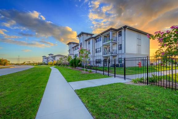 A residential building with a walkway in front of it.