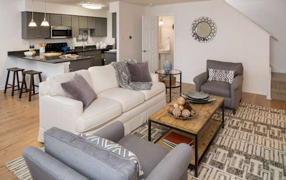 A living room with a white couch and a coffee table.