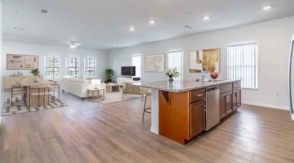 A spacious kitchen with wooden floors and a large island.