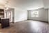 A large empty room with wooden floors and a window.