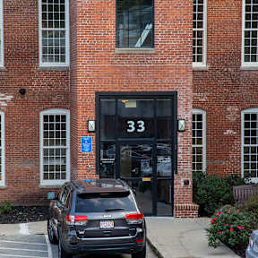 Building entrance with number 33 signage at Star Mill Lofts Apartments, Middleboro, 02370