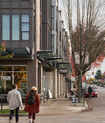 people walking down the street in front of a building