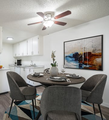 a dining area with a table and chairs and a kitchen in the background at Kirkwood Meadows, Idaho, 83201