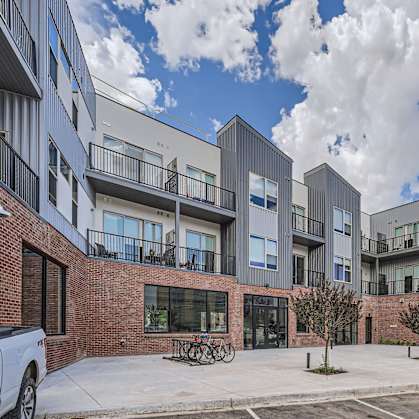 a picture of an apartment complex with a blue sky in the background