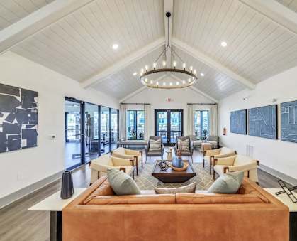 a living room with couches and chairs and a chandelier
