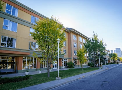a building on a street with trees in front of it