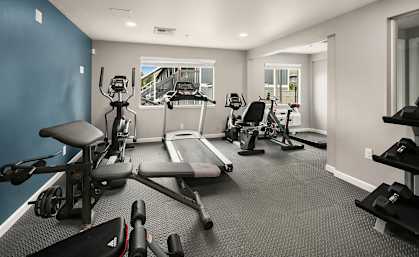 A spacious home gym with a variety of exercise equipment.