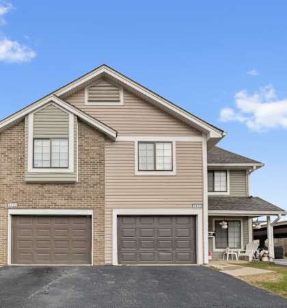 A two-story house with a garage is shown in the image.