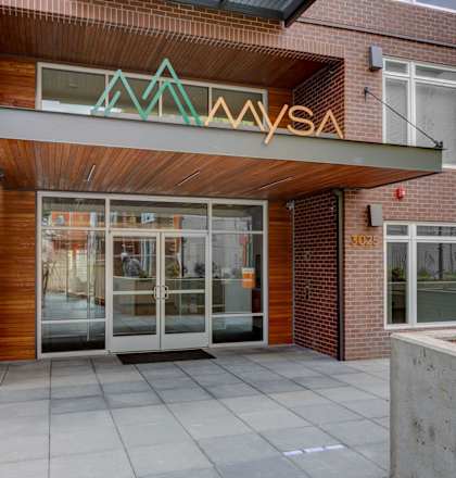the front entrance of a building with glass doors