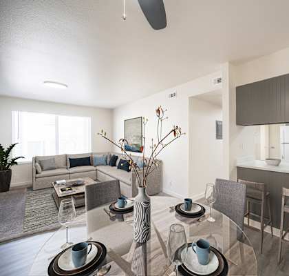 a living room and kitchen with a glass table and chairs at Summit, Pocatello, ID