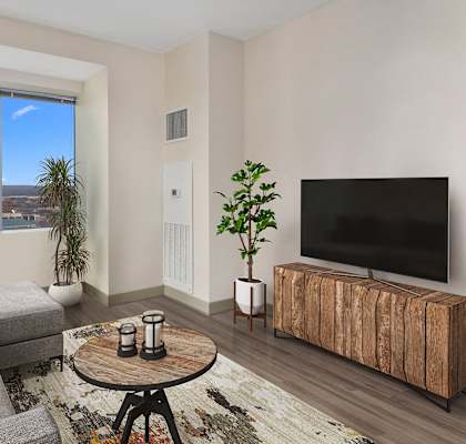 an apartment living room with a couch and a tv