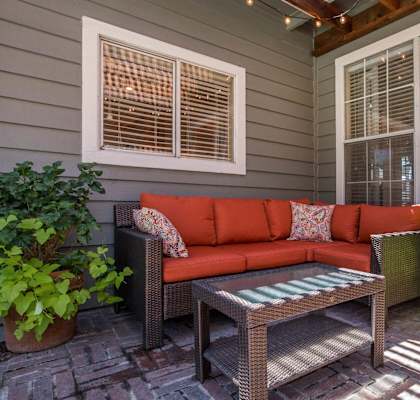 a patio with a couch and a table on a porch