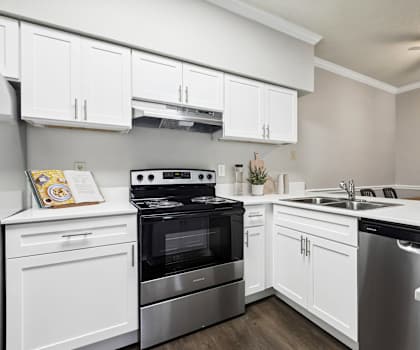 a kitchen with stainless steel appliances and white cabinets