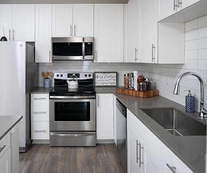 Kitchen with white cabinets at Pointe at Lake Crabtree Apartments, Morrisville, 27560