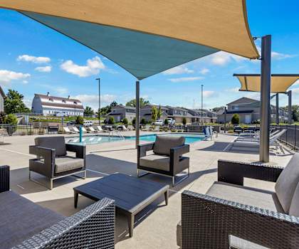 A sunny day at the poolside with lounge chairs and umbrellas.