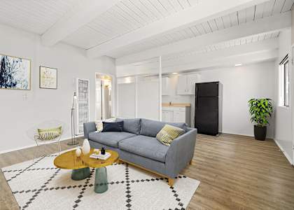 A living room with a grey couch and a coffee table.