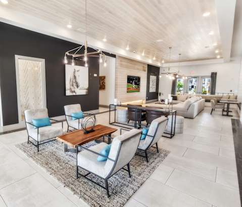 A modern living room with a wooden coffee table and blue cushions.