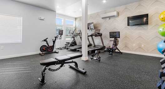 A spacious home gym with a variety of exercise equipment.