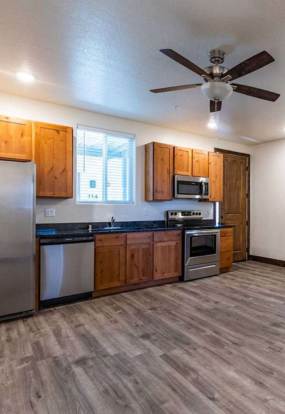 a kitchen with a stove top oven next to a refrigerator